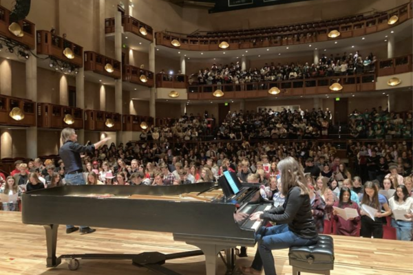 pianist performing in front of crowded concert hall