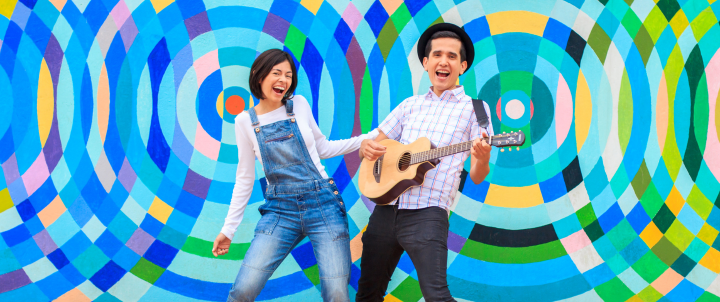 two people performing, one is playing guitar