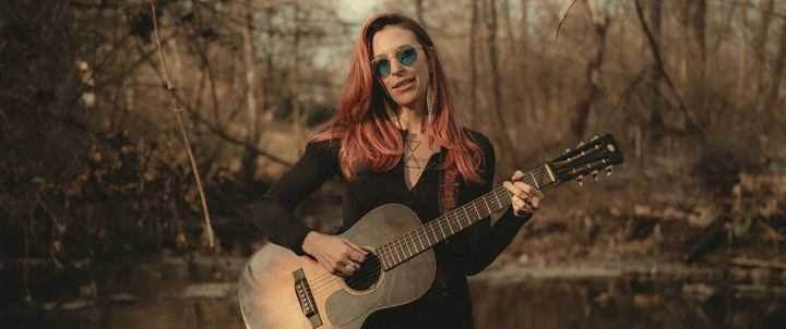 a performer playing guitar