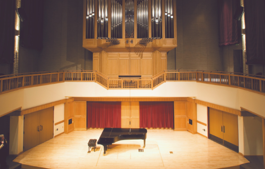 illuminated concert hall stage with piano