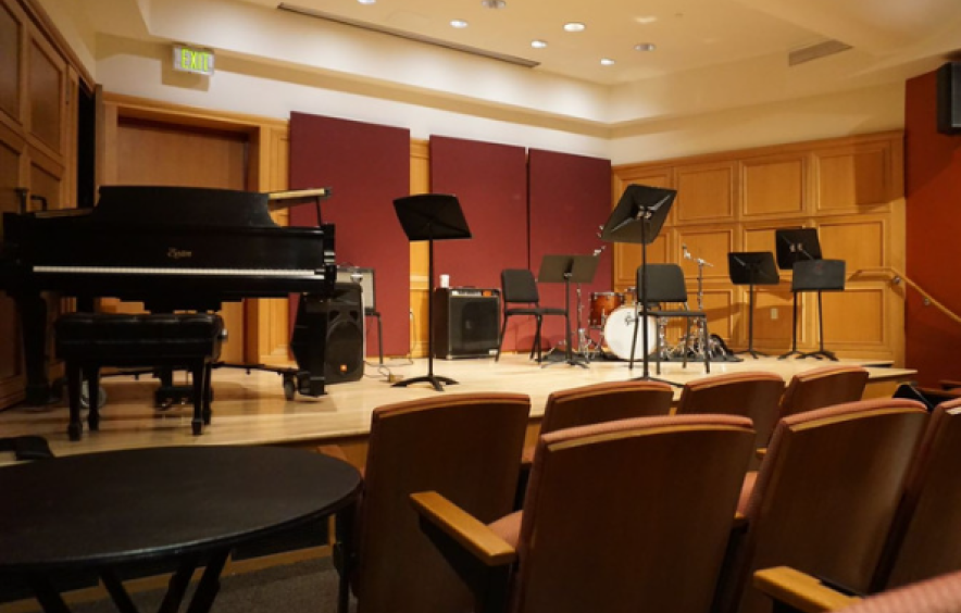 recital space stage with piano, drumkit, music stands