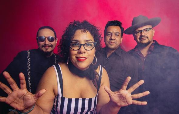 four members of la santa cecilia