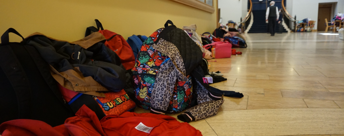 hallway filled with children's backpacks